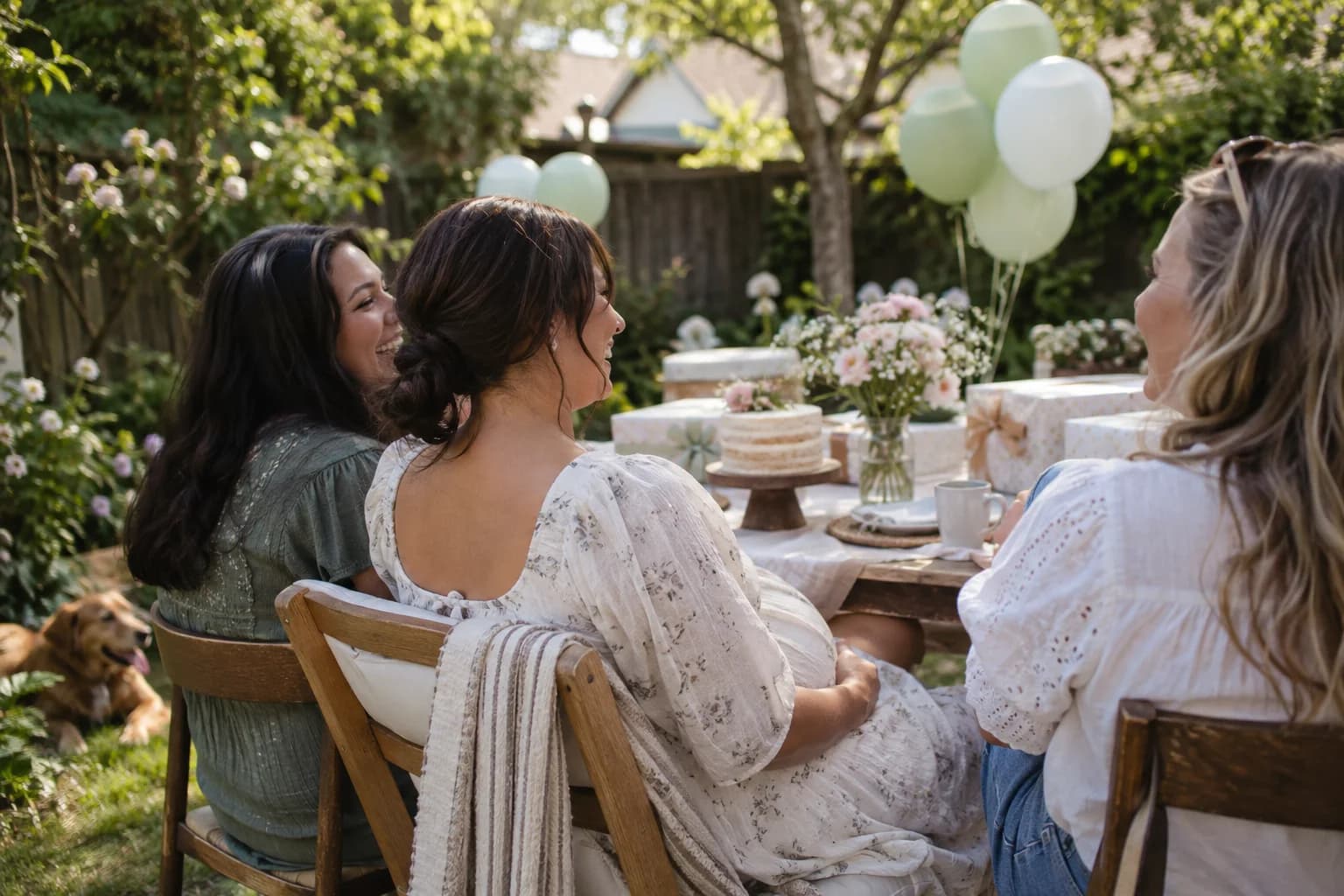 An expectant parent celebrating with friends in a garden