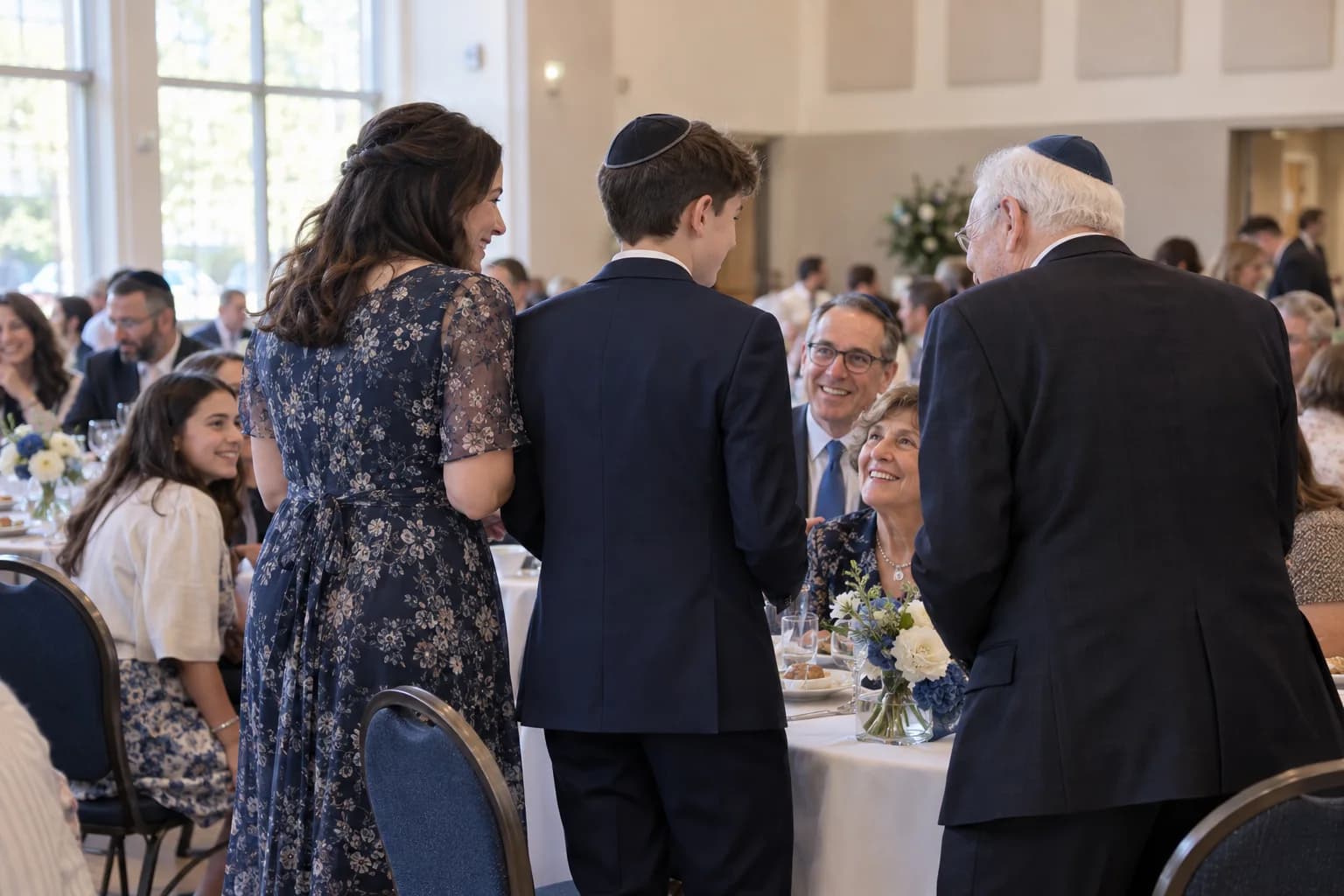 A young boy in a kippah celebrating his bar mitzvah with family