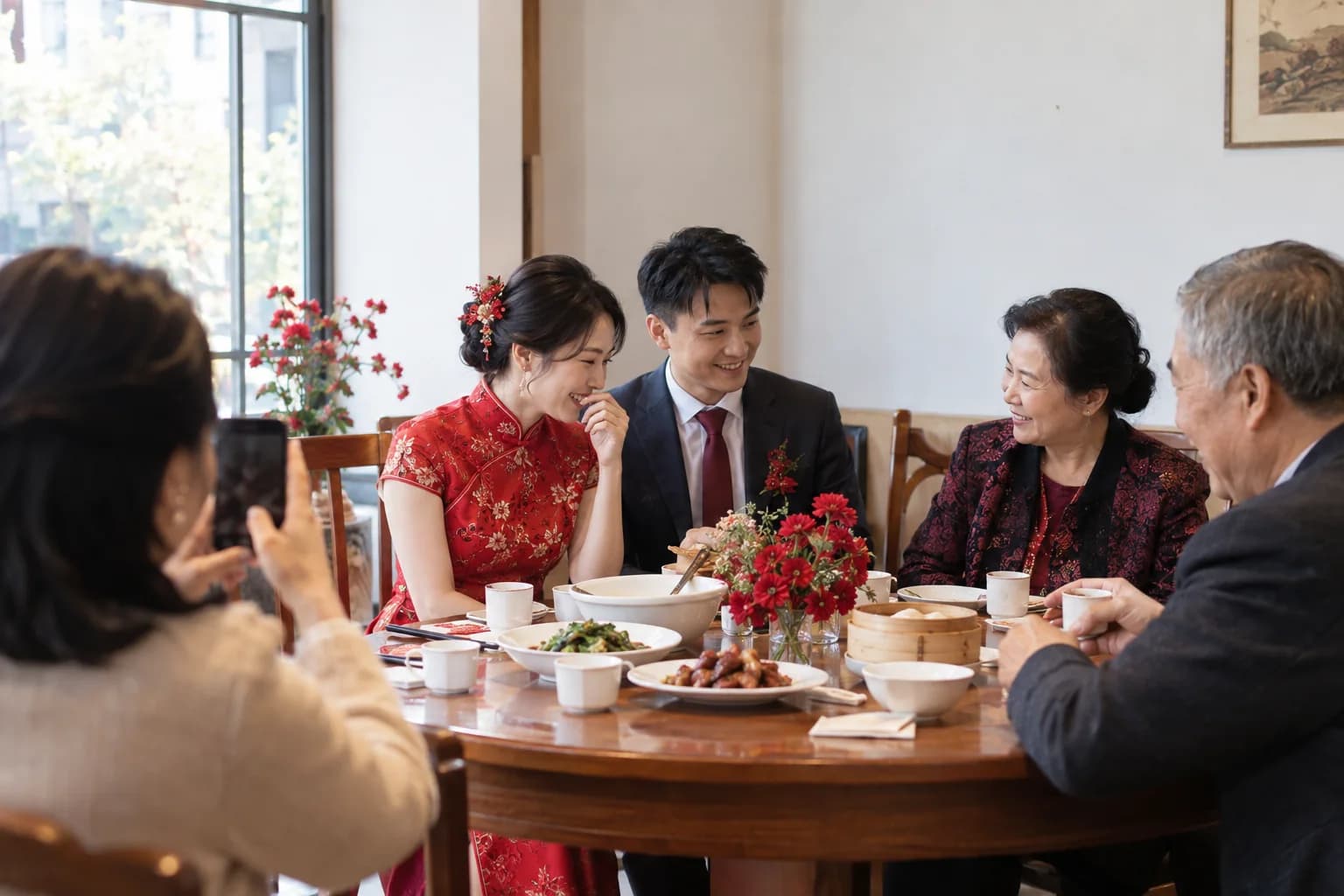 A couple sharing tea with family during a Chinese wedding celebration
