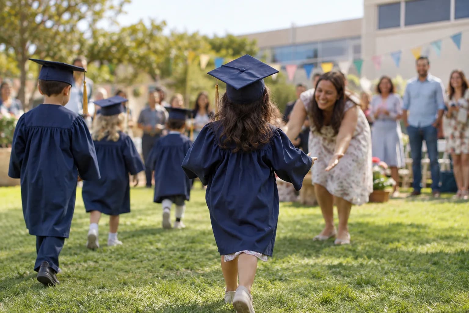 Young children celebrating preschool graduation with their families