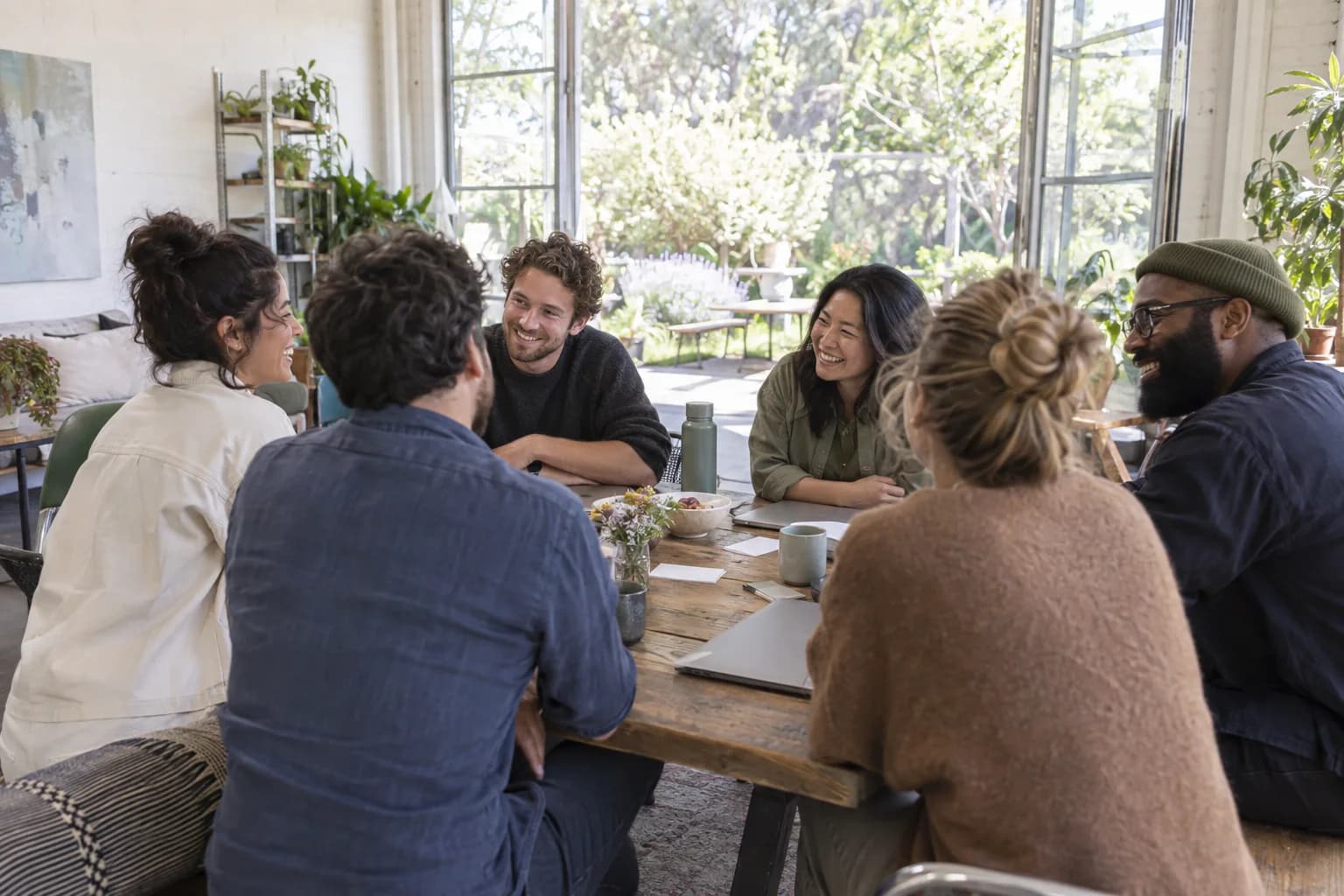 Colleagues working together around a table at a team workshop